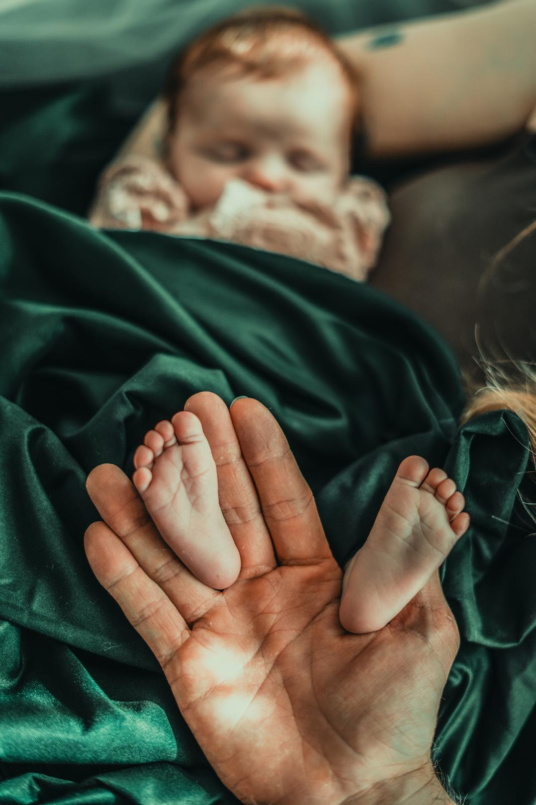 Baby feet in father's hand